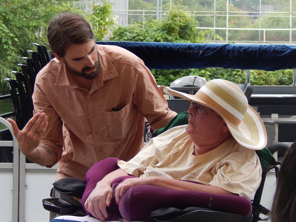 woman in wheelchair and male caregiver