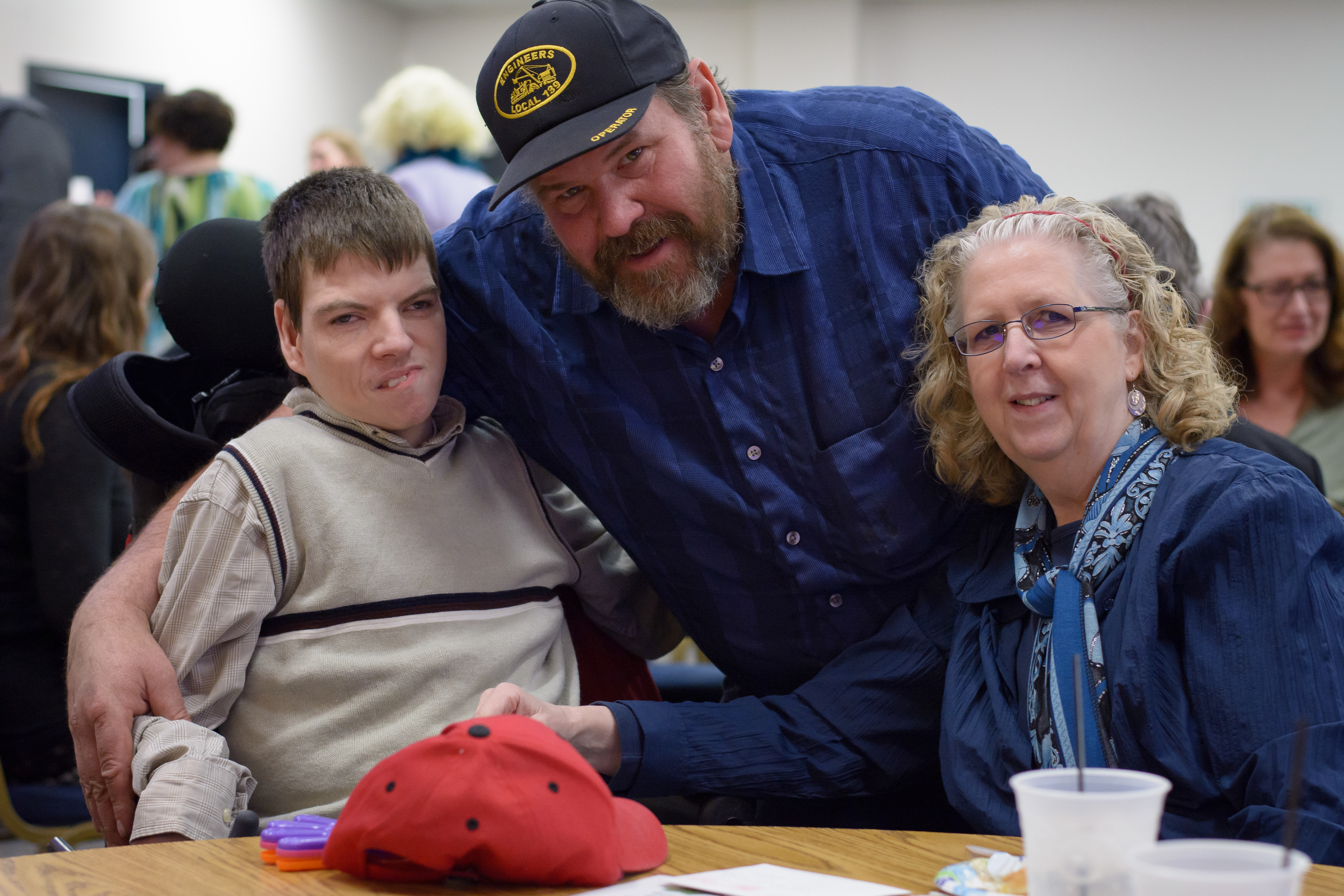 young man, man in baseball cap, woman